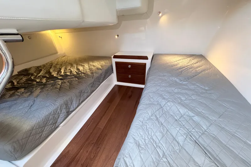 Slide: The Image of 2025 NorthCoast 415 HT cabin interior with twin beds and wooden flooring. - 27