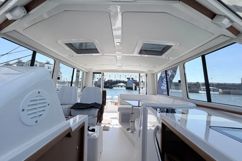 Slide: The Image of Interior of 2025 NorthCoast 415 HT boat with modern seating and panoramic windows. - 28