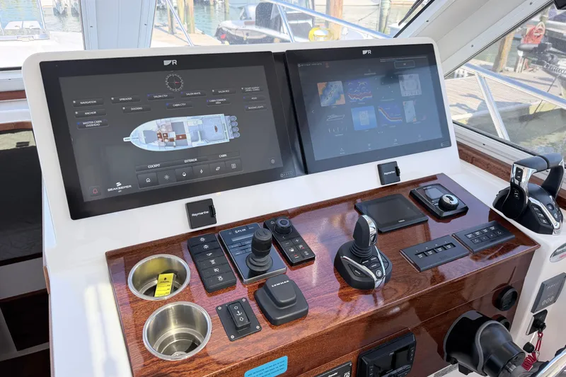 Slide: The Image of Helm of 2025 NorthCoast 415 HT boat with advanced navigation displays and controls. - 29