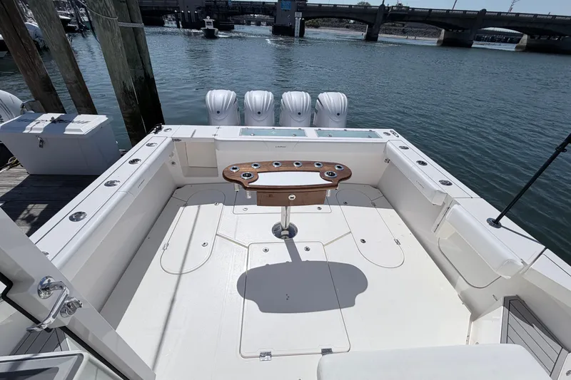 Slide: The Image of 2025 NorthCoast 415 HT boat deck with fishing rod holders and outboard motors. - 3