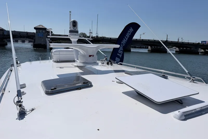 Slide: The Image of 2025 NorthCoast 415 HT boat deck with radar, docked near a bridge. - 31
