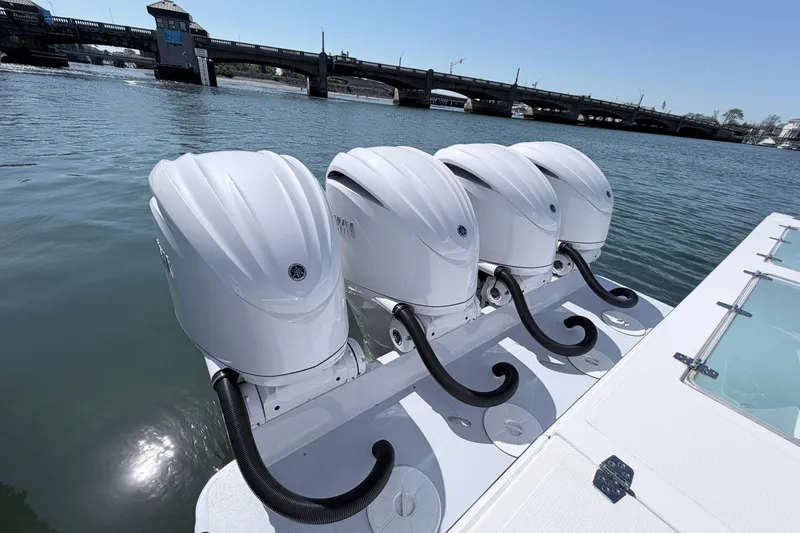 Slide: The Image of Four powerful outboard motors on a 2025 NorthCoast 415 HT boat, near a bridge. - 4