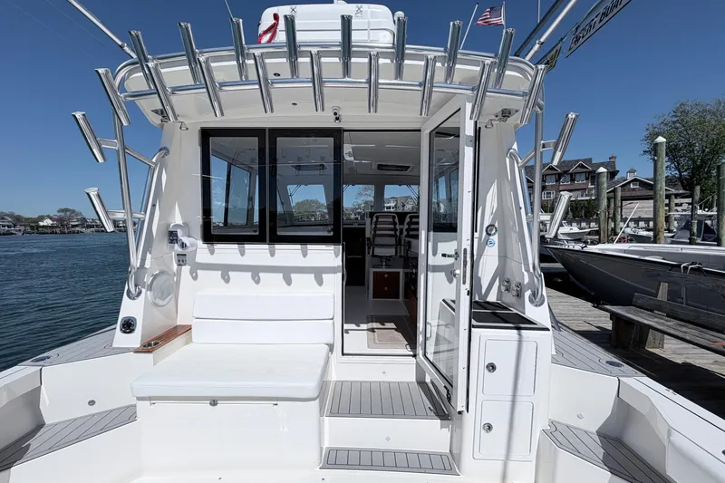 Slide: The Image of 2025 NorthCoast 415 HT boat docked, showcasing spacious deck and modern design. - 5