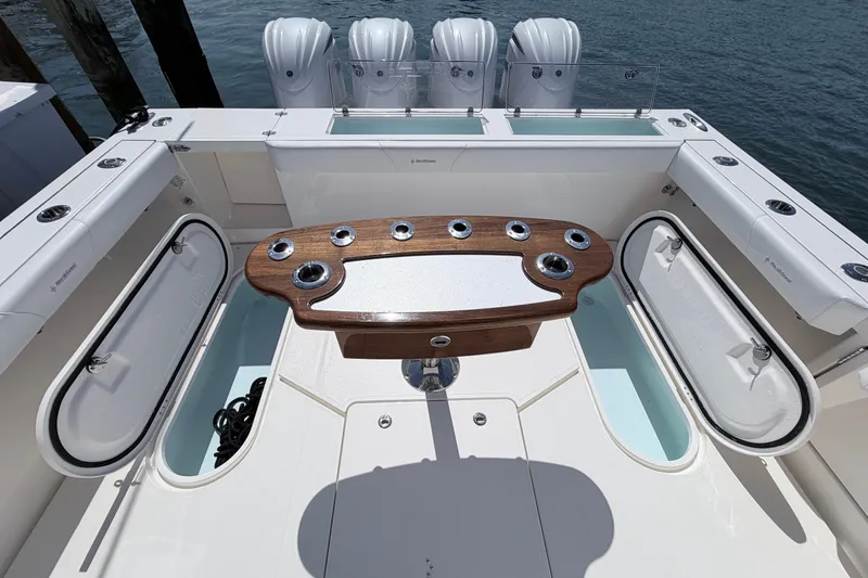 Slide: The Image of 2025 NorthCoast 415 HT boat deck with fishing rod holders and storage compartments. - 6