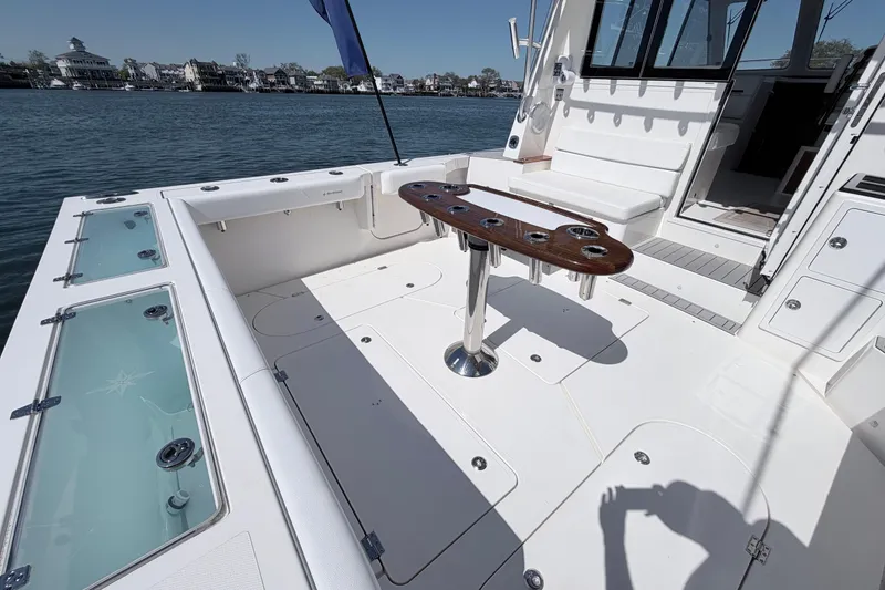 Slide: The Image of 2025 NorthCoast 415 HT boat deck with seating and fishing rod holders. - 7