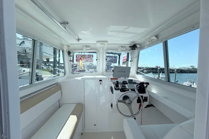 Slide: The Image of Interior of 2018 Steiger Craft 25 Chesapeake boat with steering wheel and navigation equipment. - 10