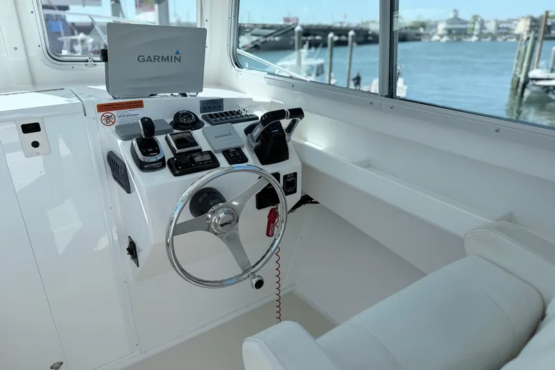 Slide: The Image of Steiger Craft 25 Chesapeake 2018 boat helm with Garmin navigation system, overlooking marina. - 12