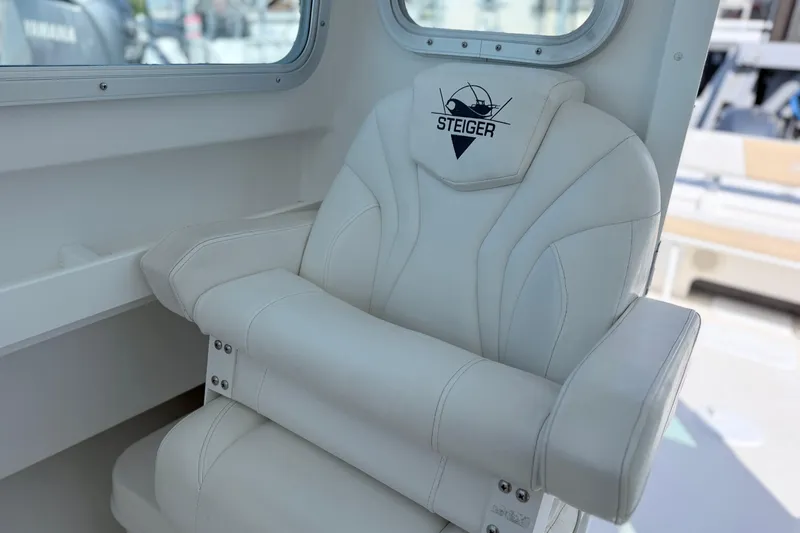 Slide: The Image of White captain's chair on 2018 Steiger Craft 25 Chesapeake boat, featuring logo embroidery. - 14