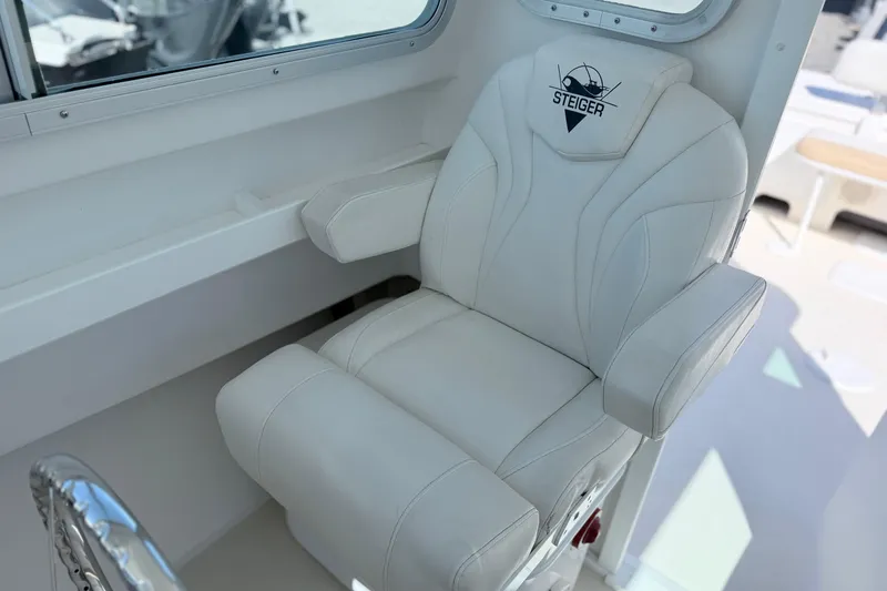 Slide: The Image of Captain's chair on 2018 Steiger Craft 25 Chesapeake boat, featuring white upholstery and armrests. - 15