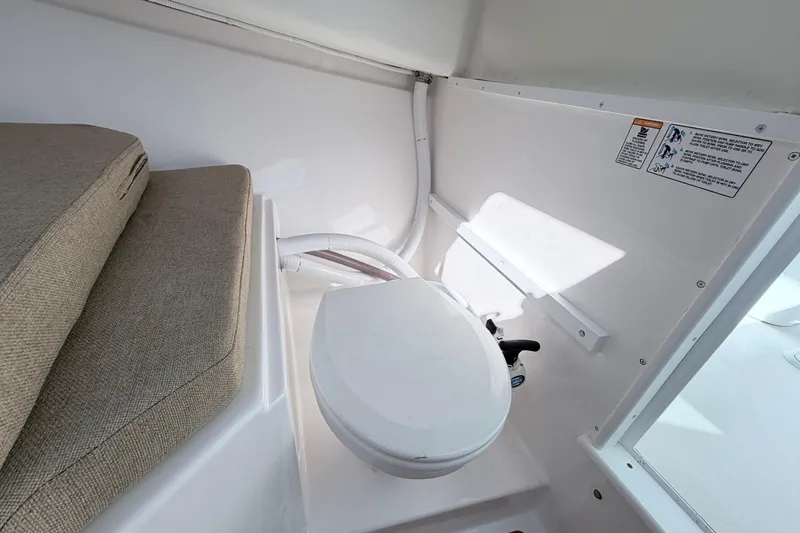 Slide: The Image of Interior of 2018 Steiger Craft 25 Chesapeake boat featuring a compact marine toilet. - 16
