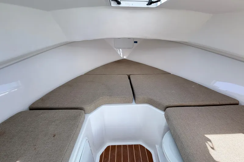 Slide: The Image of 2018 Steiger Craft 25 Chesapeake cabin interior with cushioned seating and wooden flooring. - 17