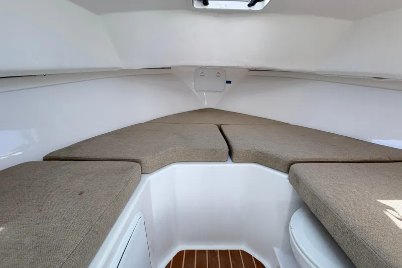 Slide: The Image of 2018 Steiger Craft 25 Chesapeake cabin interior with cushioned seating and wooden flooring. - 18