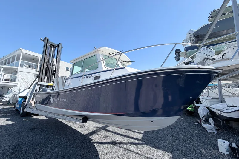 Slide: The Image of 2018 Steiger Craft 25 Chesapeake boat on trailer, displayed outdoors under clear blue sky. - 3