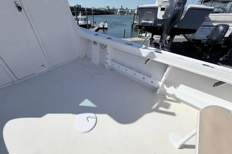 Slide: The Image of 2018 Steiger Craft 25 Chesapeake boat deck with storage and seating, docked by the water. - 7