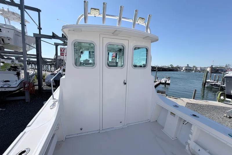 Slide: The Image of 2018 Steiger Craft 25 Chesapeake boat docked, showcasing cabin and waterfront view. - 8