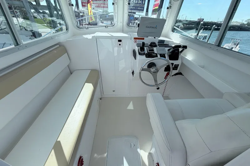 Slide: The Image of 2018 Steiger Craft 25 Chesapeake boat interior with helm, seating, and Garmin navigation system. - 9