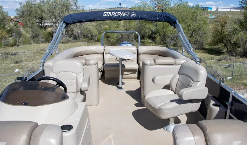 Slide: The Image of 2017 Starcraft EX23 R pontoon boat with seating area and table. - 7