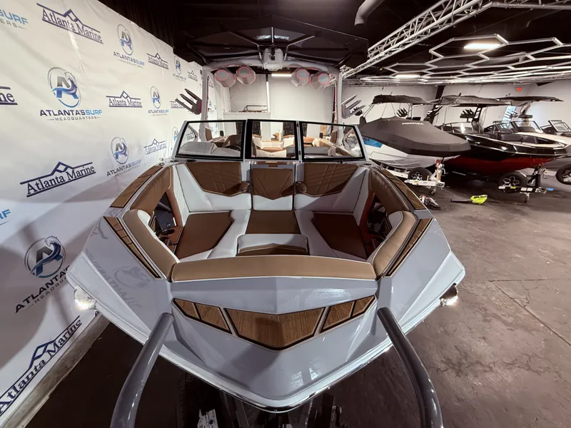 Slide: The Image of 2024 Tigé Ultré 23ZX boat displayed in showroom. - 11