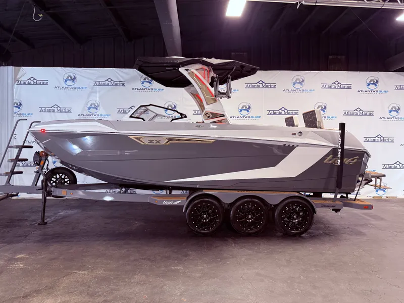 Slide: The Image of 2024 Tigé Ultré 23ZX boat on trailer in showroom. - 12
