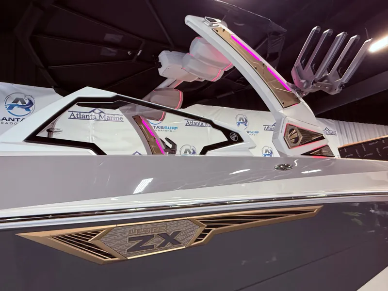 Slide: The Image of 2024 Tigé Ultré 23ZX boat with sleek design and lighting. - 16