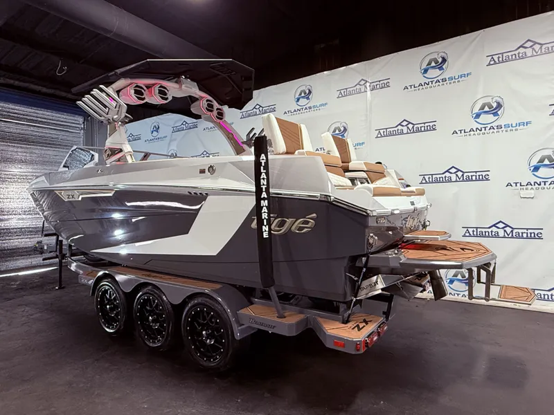 Slide: The Image of 2024 Tigé Ultré 23ZX boat displayed in a showroom. - 3