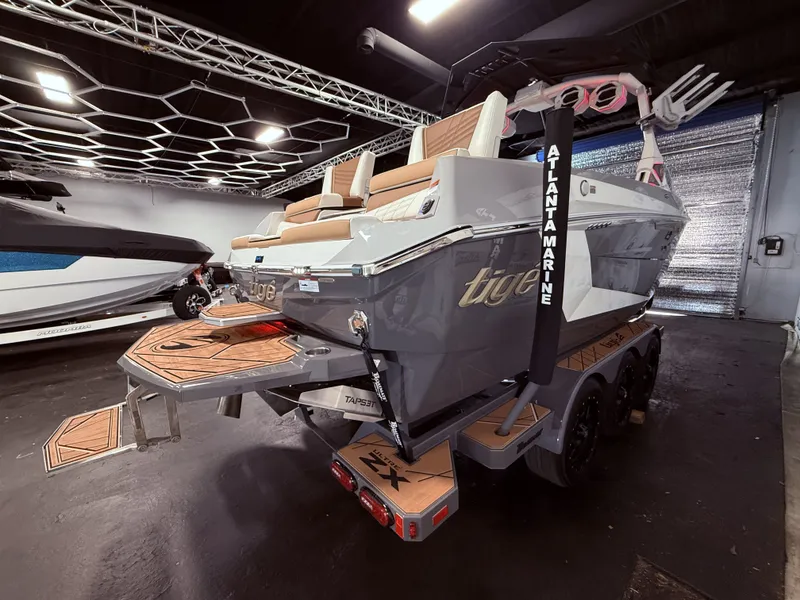 Slide: The Image of 2024 Tigé Ultré 23ZX boat displayed in showroom. - 8
