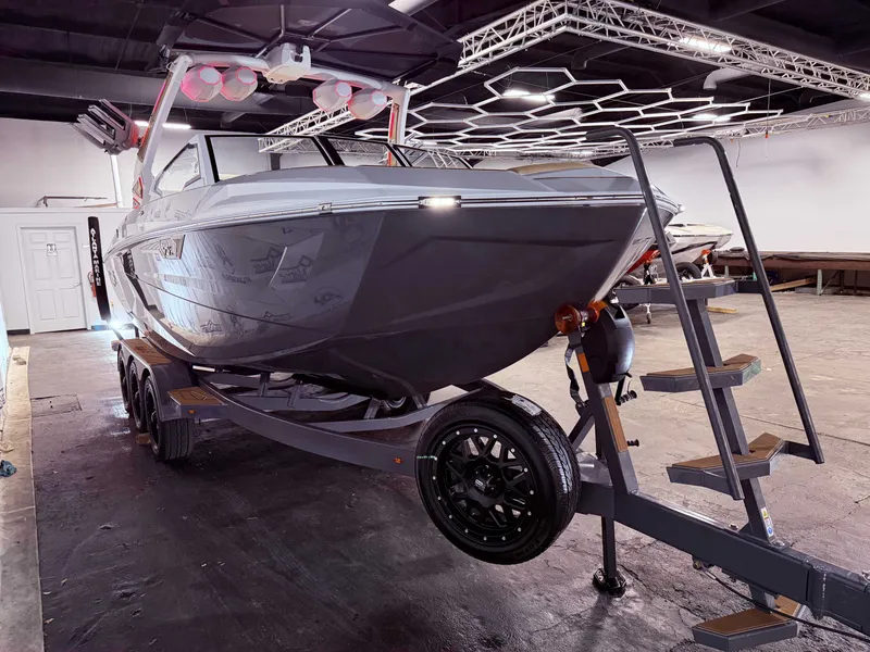 Slide: The Image of 2024 Tigé Ultré 23ZX boat displayed in a showroom. - 9