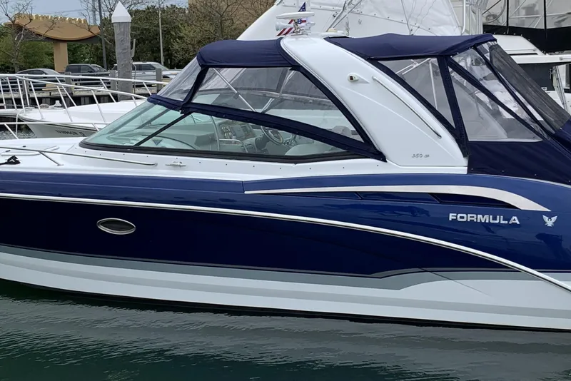 The Image of 2011 Formula 350 Sun Sport boat docked, featuring sleek blue and white design. - 0