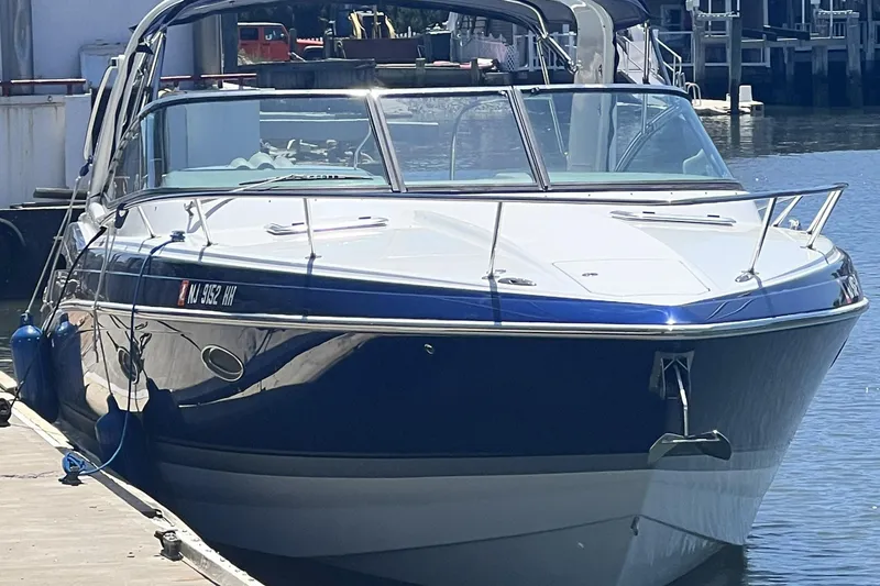 Slide: The Image of 2011 Formula 350 Sun Sport boat docked at marina, featuring sleek blue and white design. - 2