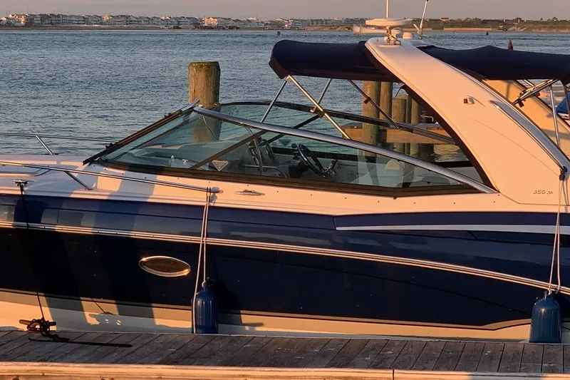 Slide: The Image of 2011 Formula 350 Sun Sport boat docked by the water at sunset. - 3