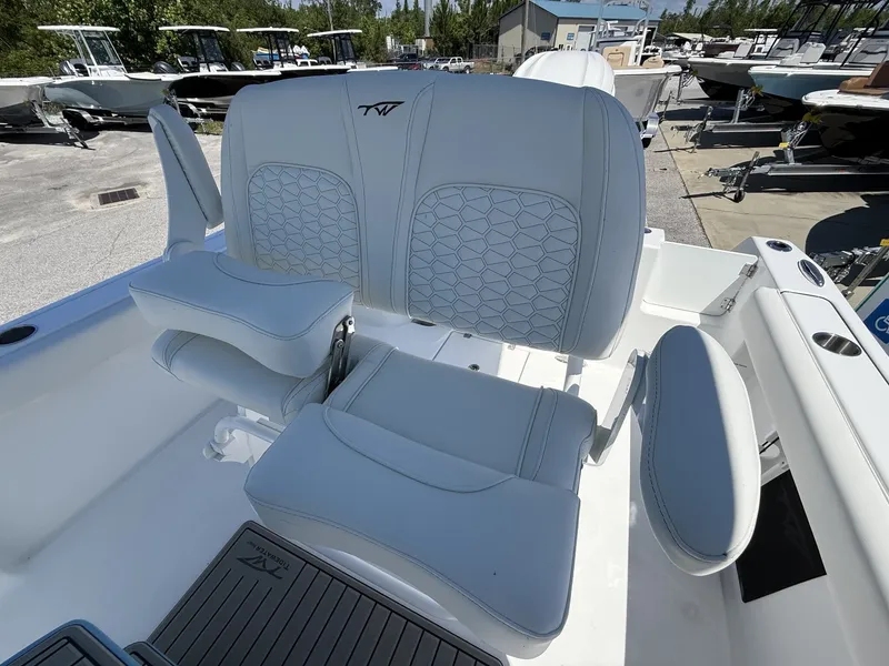 Slide: The Image of 2026 Tidewater 232 CC Adventure boat seat in a marina. - 12