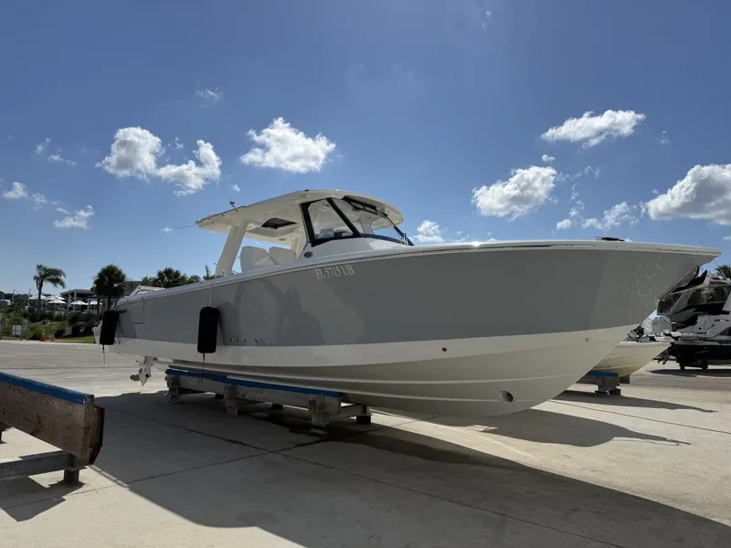 The Image of 2026 Pursuit S 358 Sport boat on a dock under sunny skies. - 1