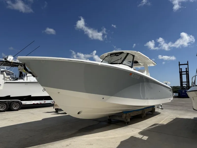 Slide: The Image of 2026 Pursuit S 358 Sport boat on a trailer under blue sky. - 4