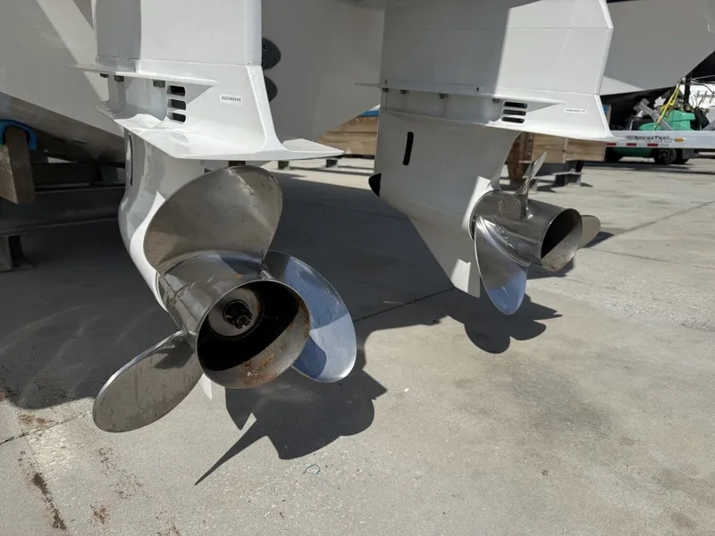 Slide: The Image of 2026 Pursuit S 358 Sport boat engines and propellers on concrete surface. - 8