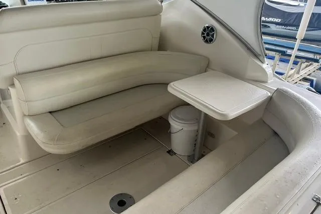Slide: The Image of 1999 Cruisers Yachts 3075 Express interior with seating and table, showcasing luxury design. - 11