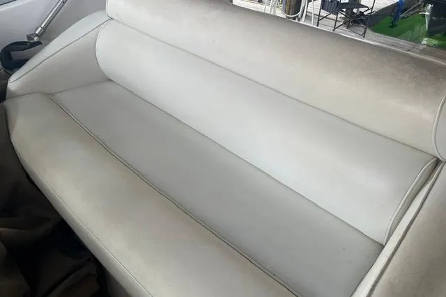 Slide: The Image of White leather seating on a 1999 Cruisers Yachts 3075 Express boat. - 13