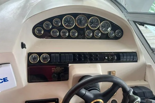 Slide: The Image of 1999 Cruisers Yachts 3075 Express dashboard with gauges and steering wheel. - 6
