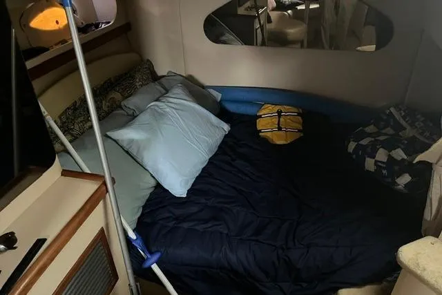 Slide: The Image of Cozy cabin interior of 1999 Cruisers Yachts 3075 Express with bed and pillows. - 8