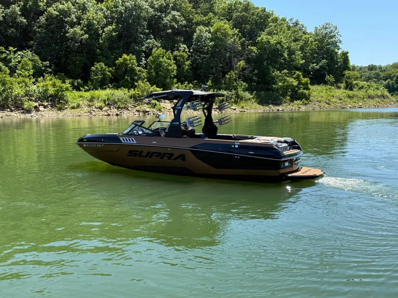 Slide: The Image of 2021 Supra SE 550 boat on a serene lake. - 17