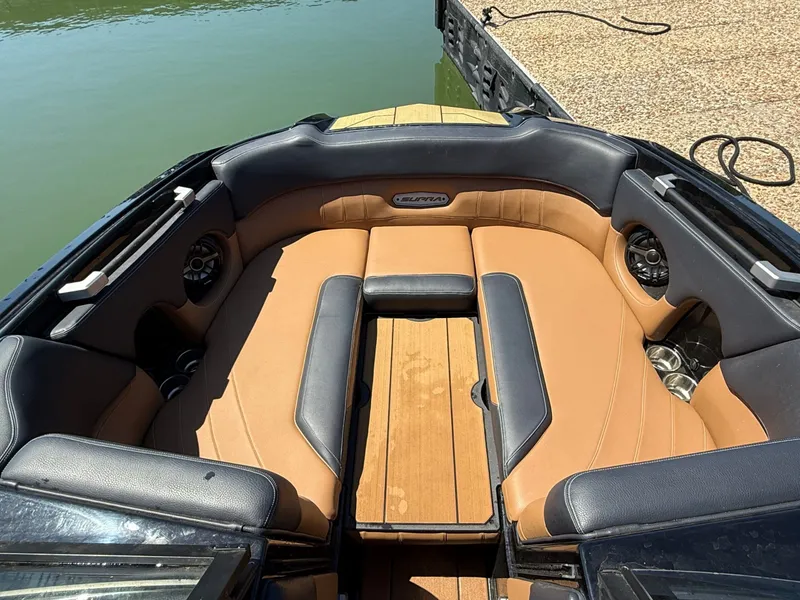 Slide: The Image of Interior of a 2021 Supra SE 550 boat by the water. - 20