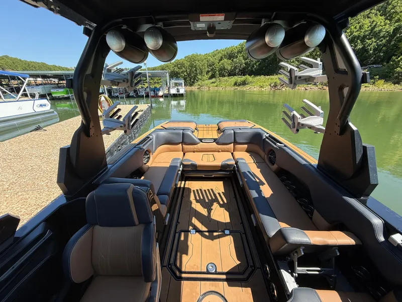 Slide: The Image of Interior of a 2021 Supra SE 550 boat by the lake. - 22