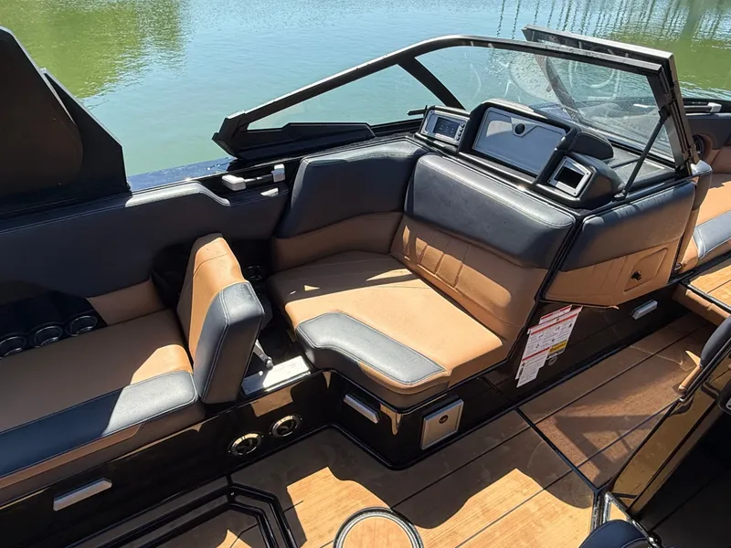 Slide: The Image of Interior of 2021 Supra SE 550 boat with brown leather seats. - 26