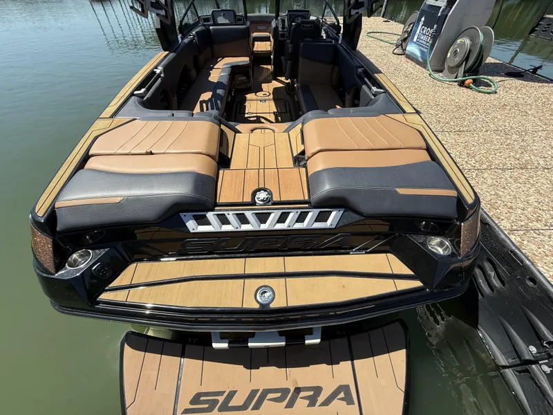 Slide: The Image of 2021 Supra SE 550 boat with luxurious interior at the dock. - 5