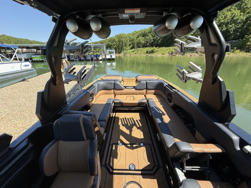 Slide: The Image of Interior of a 2021 Supra SE 550 boat by the lake. - 8
