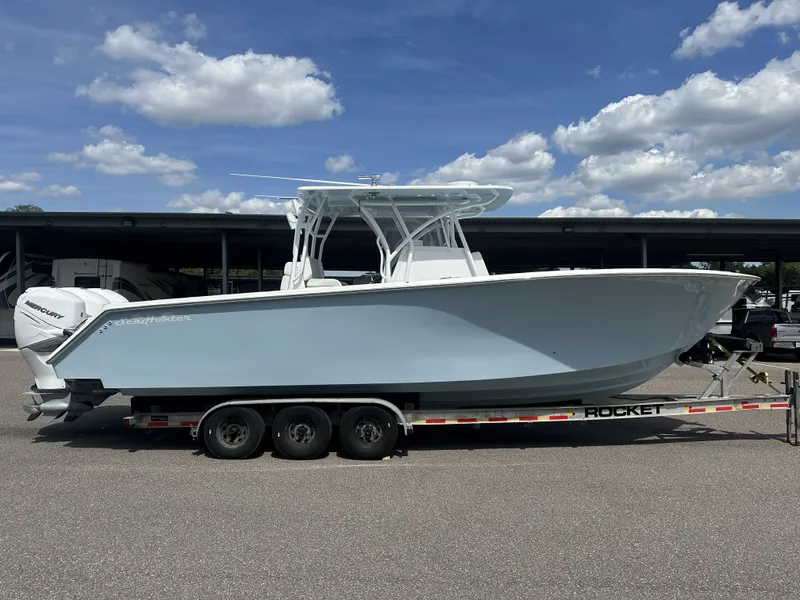 The Image of 2023 SeaHunter Tournament boat on trailer under blue sky. - 0