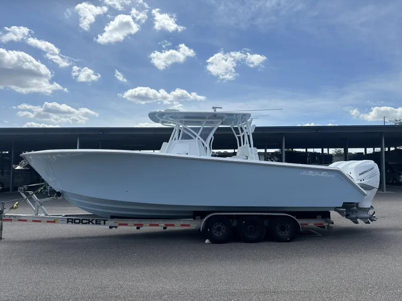 Slide: The Image of 2023 SeaHunter Tournament boat on trailer under blue sky. - 4