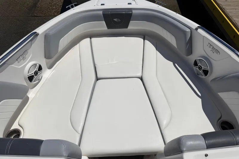 Slide: The Image of 2019 Chaparral 21 H2O Sport OB boat interior with white cushioned seating. - 11