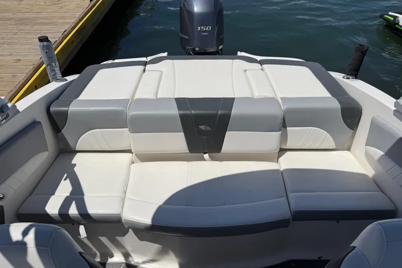 Slide: The Image of 2019 Chaparral 21 H2O Sport OB boat with cushioned seating and outboard motor. - 17