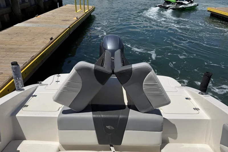 Slide: The Image of 2019 Chaparral 21 H2O Sport OB boat at dock with watercraft nearby. - 19