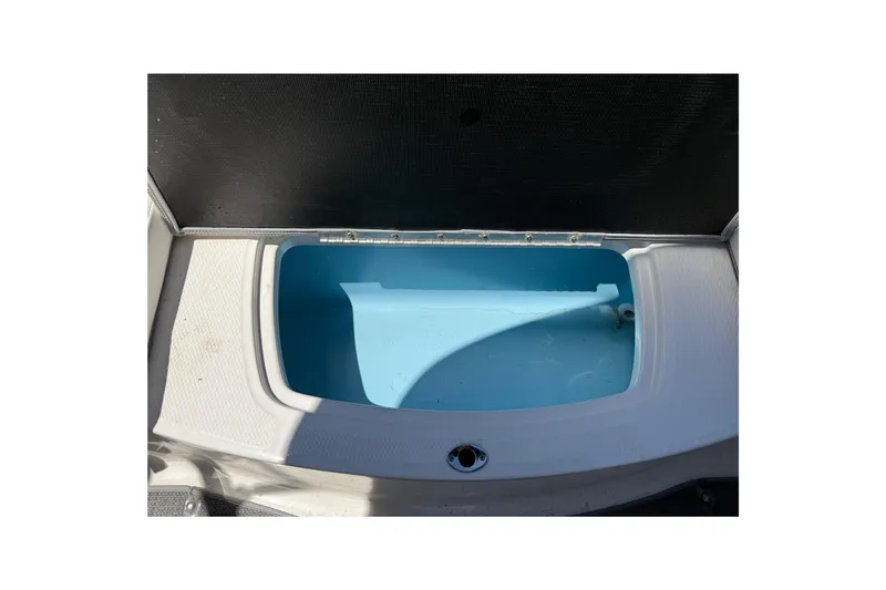 Slide: The Image of 2019 Chaparral 21 H2O Sport OB boat storage compartment, open and empty. - 20